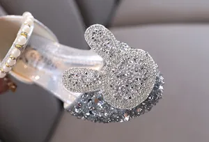 Detailed view of sparkling rhinestone bunny motif on elegant silver girls princess dance shoes