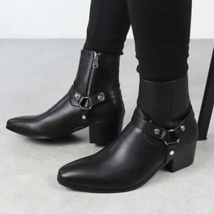 Gros plan de bottines Chelsea noires pour hommes avec bout pointu et harnais en cuir.