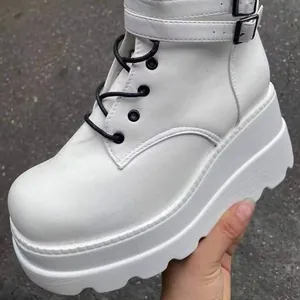 White high-top platform boots with thick soles and stylish buckle straps for women.