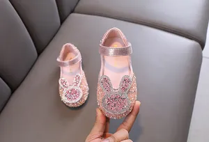 Close-up detail of pink rhinestone girls princess shoes with cute rabbit decoration