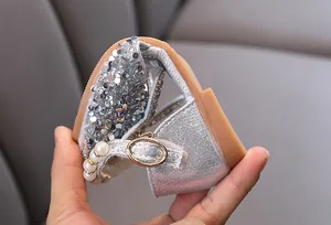 Detailed view of flexible silver glitter princess shoe with pearl strap and soft sole