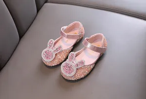 Detailed view of pink sparkling girls princess dress shoes featuring a rhinestone rabbit