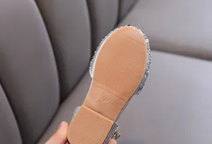 Detail view of non-slip rubber sole on sparkling silver girls princess dress shoes
