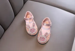 Top view of pink girl's princess shoes with sparkly rhinestones and rabbit design