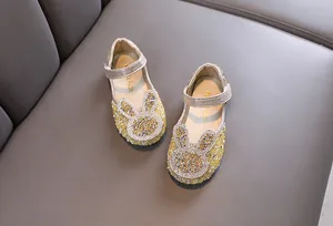 Detailed view of elegant gold rhinestone princess shoes for girls with bunny design