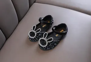 Detailed view of black sparkly girls princess shoes featuring a rhinestone rabbit design