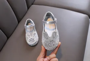 Detailed view of silver rhinestone princess shoes for girls featuring a cute bunny design