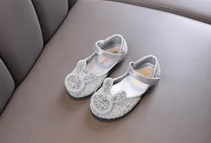 Detailed view of silver girl's princess shoes with sparkly rhinestones and bunny ears
