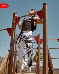 Male athlete performing pull-ups wearing white quick-dry graffiti print joggers outdoors