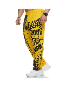 Detailed close-up of men's quick-dry yellow sports trousers with bold black text print
