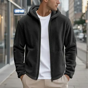 Close-up of black sherpa fleece texture on a hooded men's zip-up winter jacket.