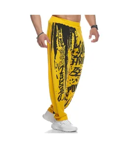 Close-up detail of men's yellow quick-dry joggers featuring bold black graffiti print