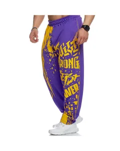 Close-up of men's purple sports fitness pants featuring bold yellow graffiti print