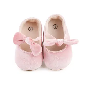 Vista detallada de zapatos de terciopelo rosa para bebé con lazo decorativo para niñas.