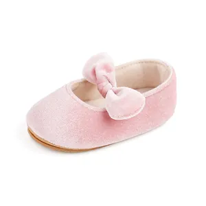 Detailed macro view of a pink velvet baby princess shoe with a plush velvet bow accent