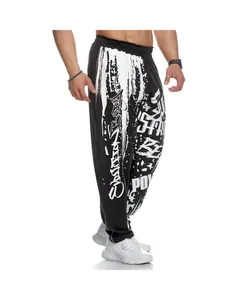 Detail view of men's loose quick-dry sports joggers with white graffiti print