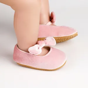 Soft pink velvet baby princess shoes with a delicate bow, perfect for infant dress wear
