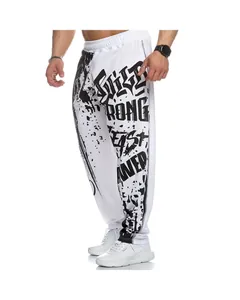 Detailed view of men's loose fitness pants with bold black graphic print on white