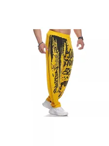Men's yellow athletic pants with bold black graffiti print for fitness and casual wear
