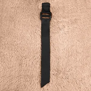 Detailed view of the black nylon adjustment strap and ladder-lock buckle on fleece jacket