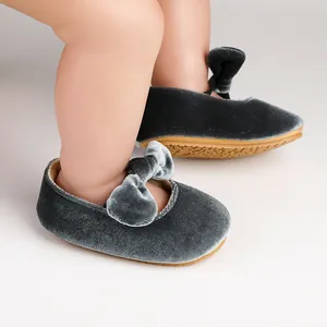 Detailed view of charcoal grey velvet baby princess shoes with a stylish soft bow.