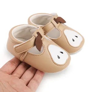 Gros plan sur des chaussures de marche pour bébé marron avec motif de poire mignon