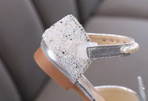 Detail of silver girl princess shoe featuring sparkling rhinestones and pearl accents