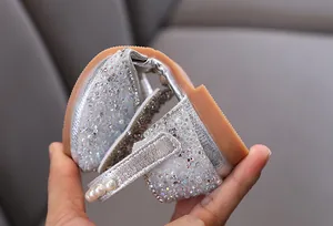 Close-up showing the flexible rubber sole of these silver rhinestone princess shoes for girls