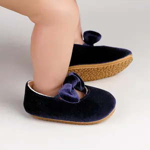 Close-up detail of navy blue velvet baby princess shoes with an elegant bow design