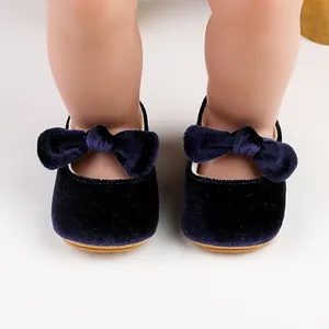 Detailed macro view of soft navy blue velvet baby shoes with elegant bow decorations