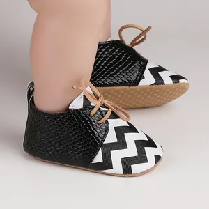 Close-up of black and white chevron baby walking shoes with anti-slip soft soles for 0-1 years.