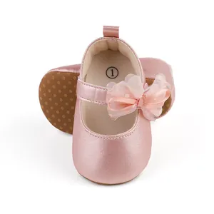 Close-up detail of pink baby girl princess walking shoes with mesh bow and non-slip sole