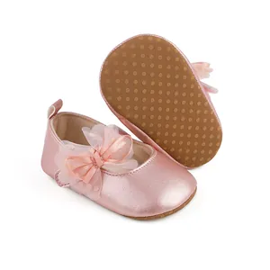 Detail of pink metallic baby princess shoes with non-slip sole and lace bow