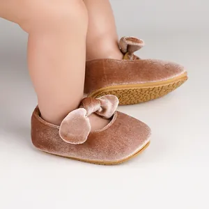 Detailed view of pink velvet baby princess shoes with a soft bow and non-slip sole