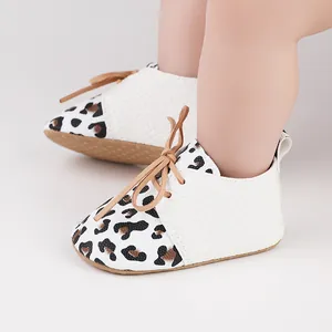 Detailed close-up of leopard print infant walker shoes with white textured faux leather