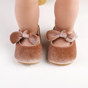 Close-up detail of soft velvet baby princess shoes with an elegant bow-knot decoration