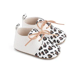 Detail view of leopard print baby walking shoes with white crocodile texture