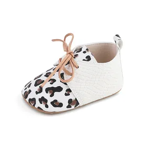 Close-up view of leopard print baby pre-walker shoes with textured white panels