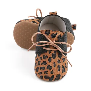 Detailed view of leopard print baby walking shoes featuring anti-slip dotted soles.