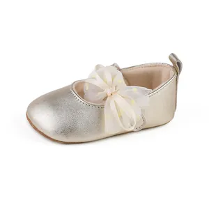 Detailed view of champagne gold baby Mary Jane shoe with lace bow and rubber sole