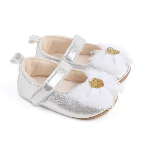 Detail of silver infant dress shoes featuring a white mesh bow and golden glitter heart.