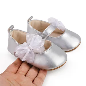 Detail showing silver baby princess shoes with white mesh bow and soft rubber sole