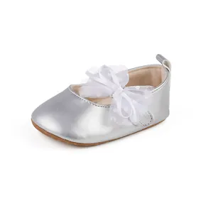 Close-up of silver baby princess walking shoe featuring a delicate lace polka dot bow