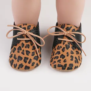 Adorable leopard print soft sole baby toddler shoes featuring tan lace-up closure detail