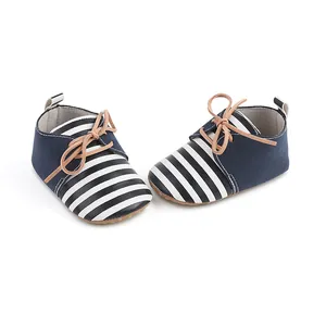 Close-up of navy and white striped baby walker shoes for infants aged 0 to 1 year.