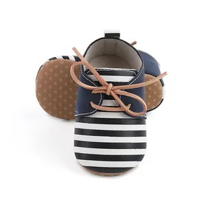 Close-up of navy and white striped baby walking shoes with anti-slip rubber soles