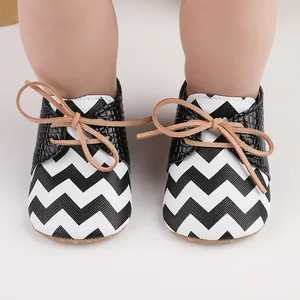 Baby walker shoes featuring black and white chevron patterns and non-slip rubber soles