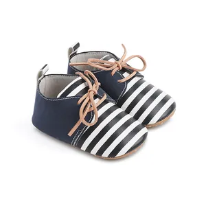 Navy blue and white striped baby walking shoes with soft tan lace details for infants