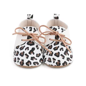 Front detail of baby walking shoes with leopard print and non-slip rubber soles