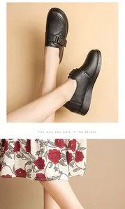 Stylish black genuine leather loafers for women with comfortable soft soles and floral skirt.